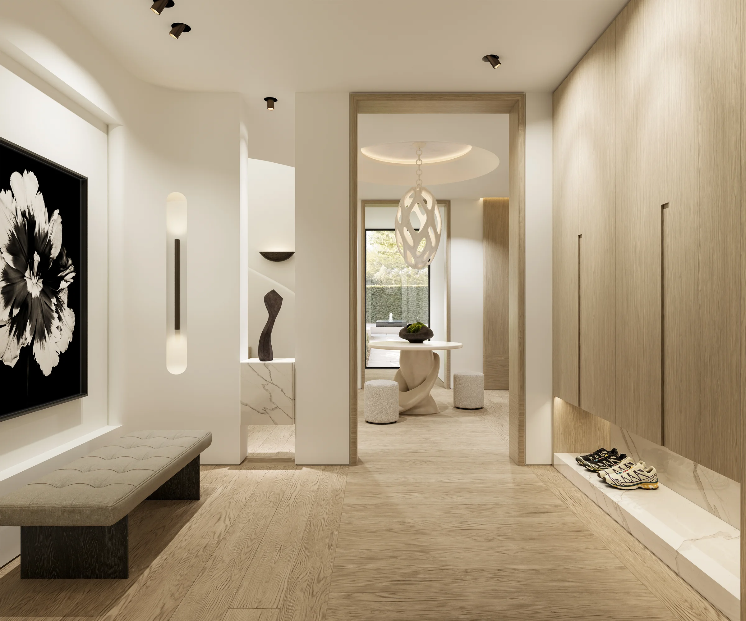 Cream-walled lobby with oak floor, marble plinth, and a far oak doorway revealing a petal-cut chandelier
