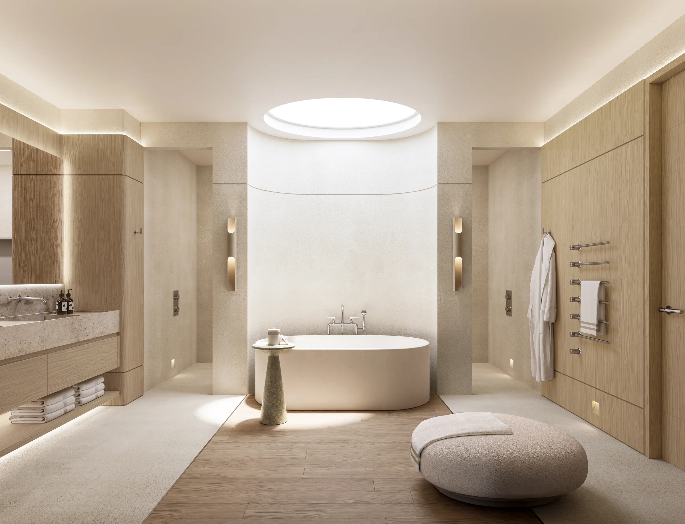Travertine ensuite with a freestanding cream bathtub, brushed-bronze fittings, mirror on a curved wall
